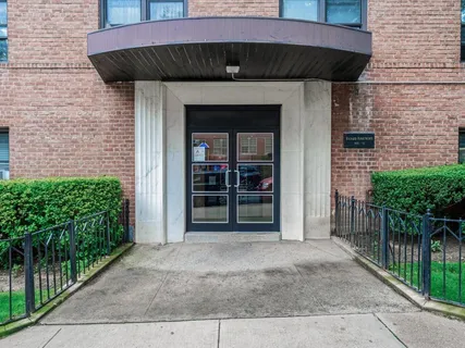 a view of a house with wooden fence