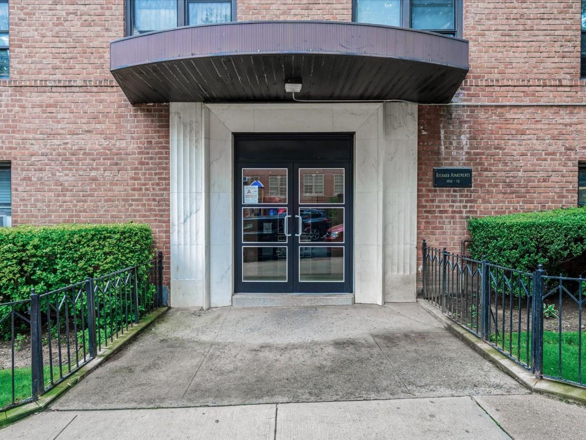 102-12 65th Avenue, Unit D22 Queens, NY 11375 - Photo 2 of 12 a view of a house with wooden fence