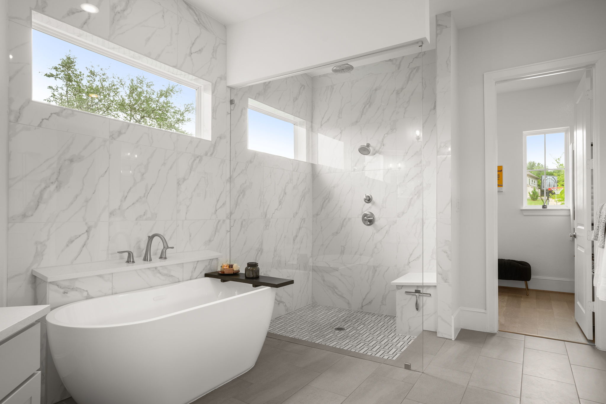 104 Lodestone Cove Austin, TX 78738 - Photo 19 of 40 Indulge in this pristine bathroom offering a freestanding tub and a spacious glass-enclosed shower.