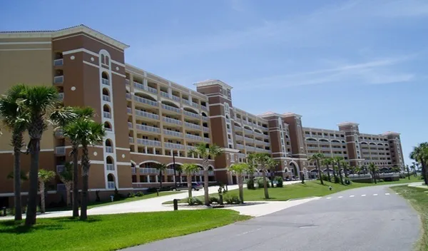 a view of a tall building next to a yard