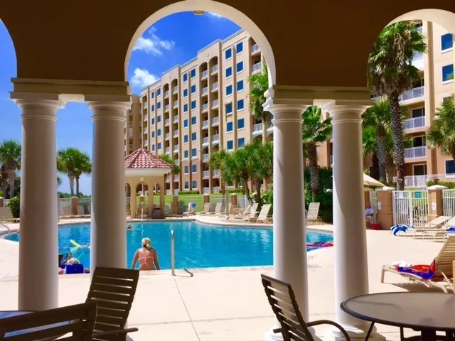 a view of a pool in the backyard of a house