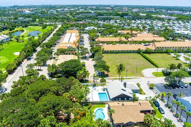 an aerial view of residential houses with outdoor space and river view