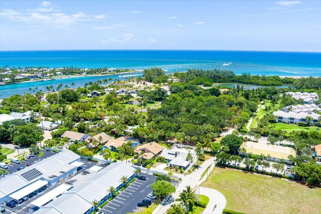 an aerial view of a house with a yard basket ball court and outdoor seating
