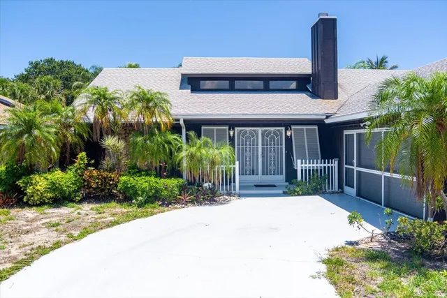 a front view of house with a garden