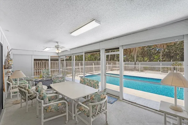 a living room with furniture a flat screen tv and a large window