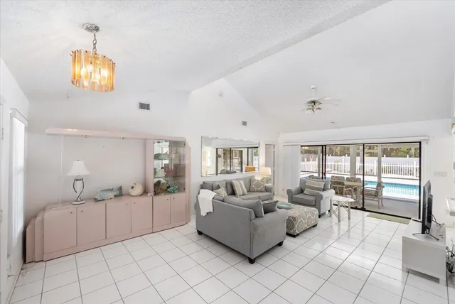a kitchen with a refrigerator a stove top oven and cabinets