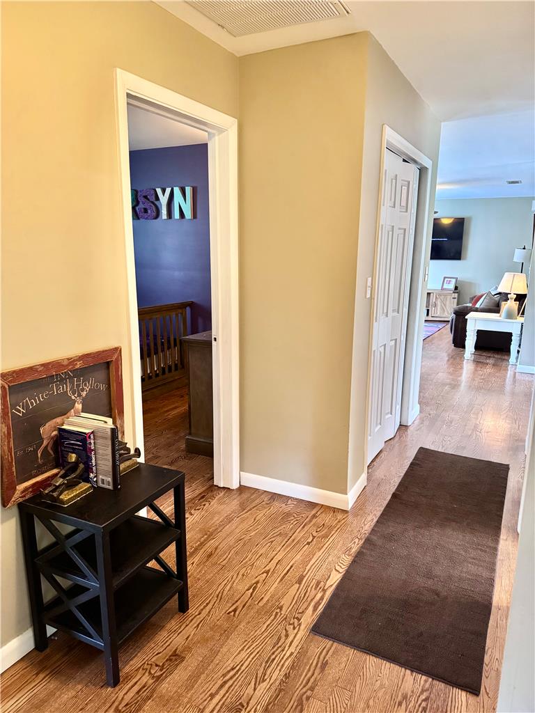 5334 Egypt Road Laurys Station, PA 18059 - Photo 17 of 55 Hardwood floors stretch through a naturally illuminated hallway, connecting living spaces.