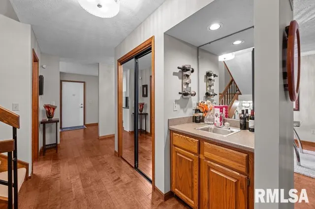 a view of a hallway to a livingroom and a livingroom with furniture