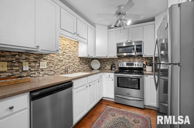 a kitchen with a refrigerator stove and microwave