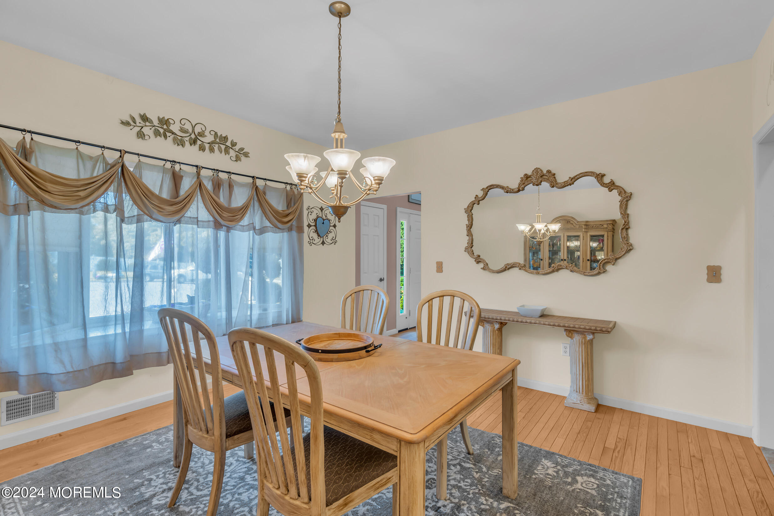 24 Ryjac Court Brick, NJ 08724 - Photo 13 of 57 a view of a dining room with furniture a chandelier and wooden floor