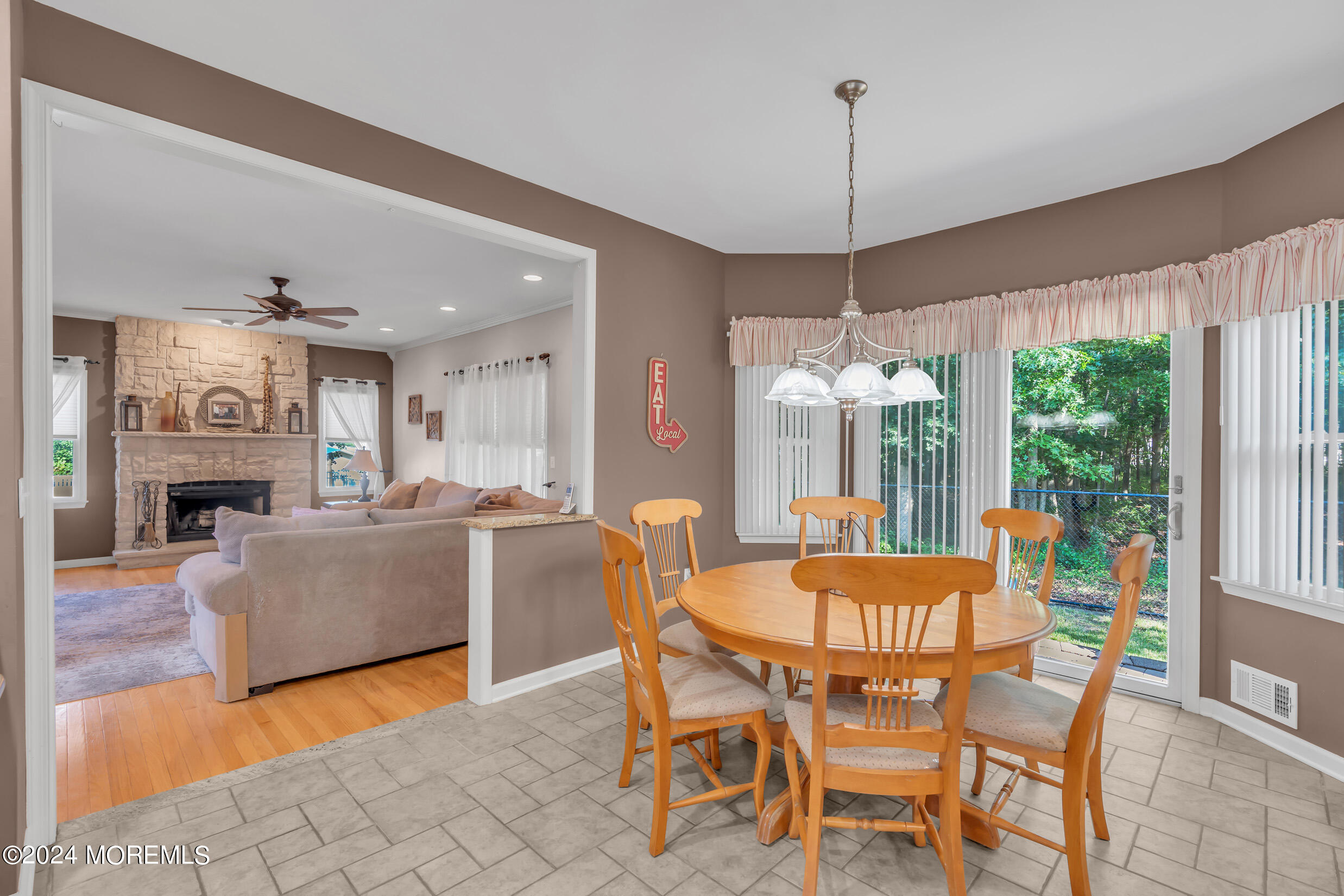 24 Ryjac Court Brick, NJ 08724 - Photo 20 of 57 a dining room with furniture a chandelier and fireplace