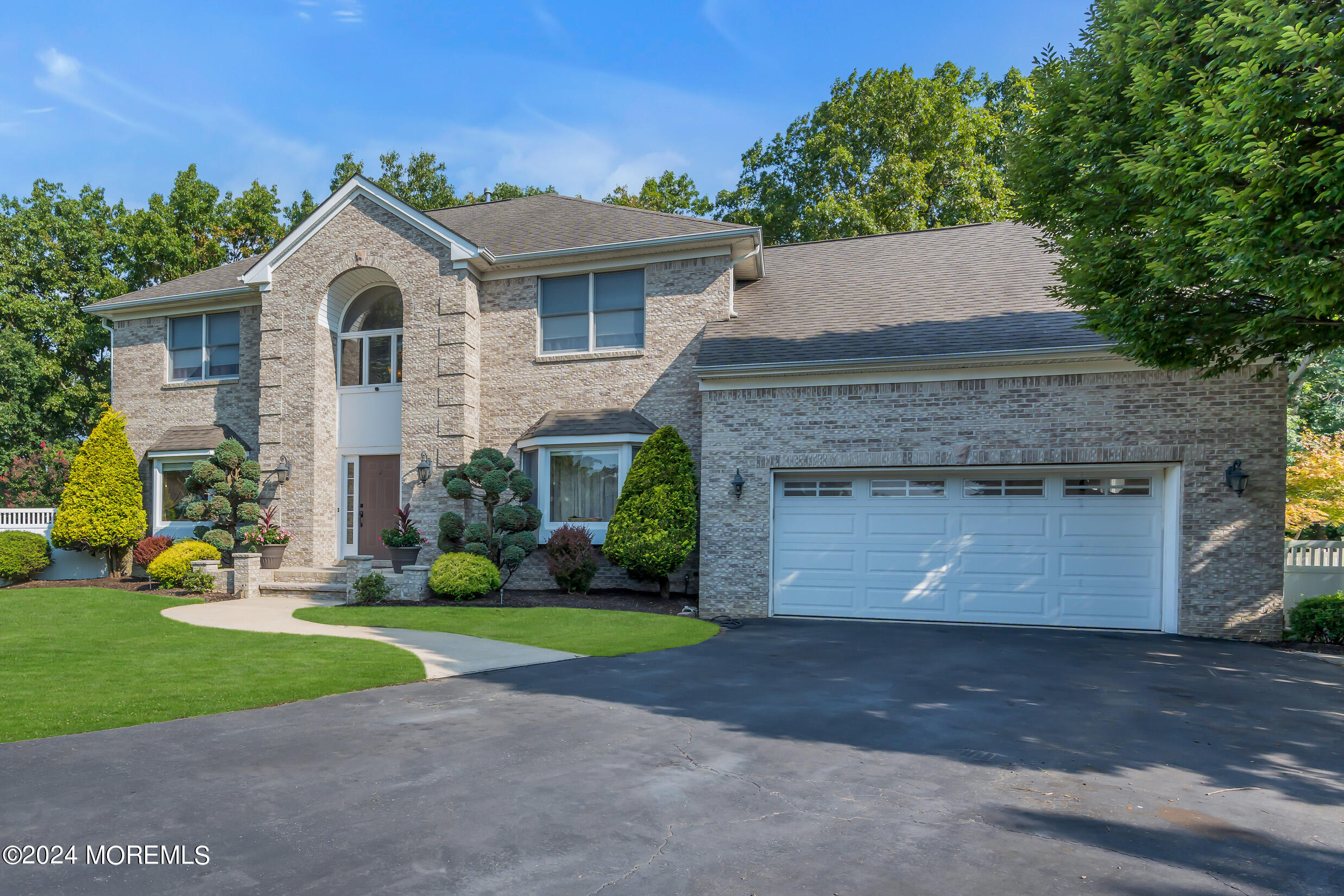 24 Ryjac Court Brick, NJ 08724 - Photo 2 of 57 a front view of a house with a yard and garage