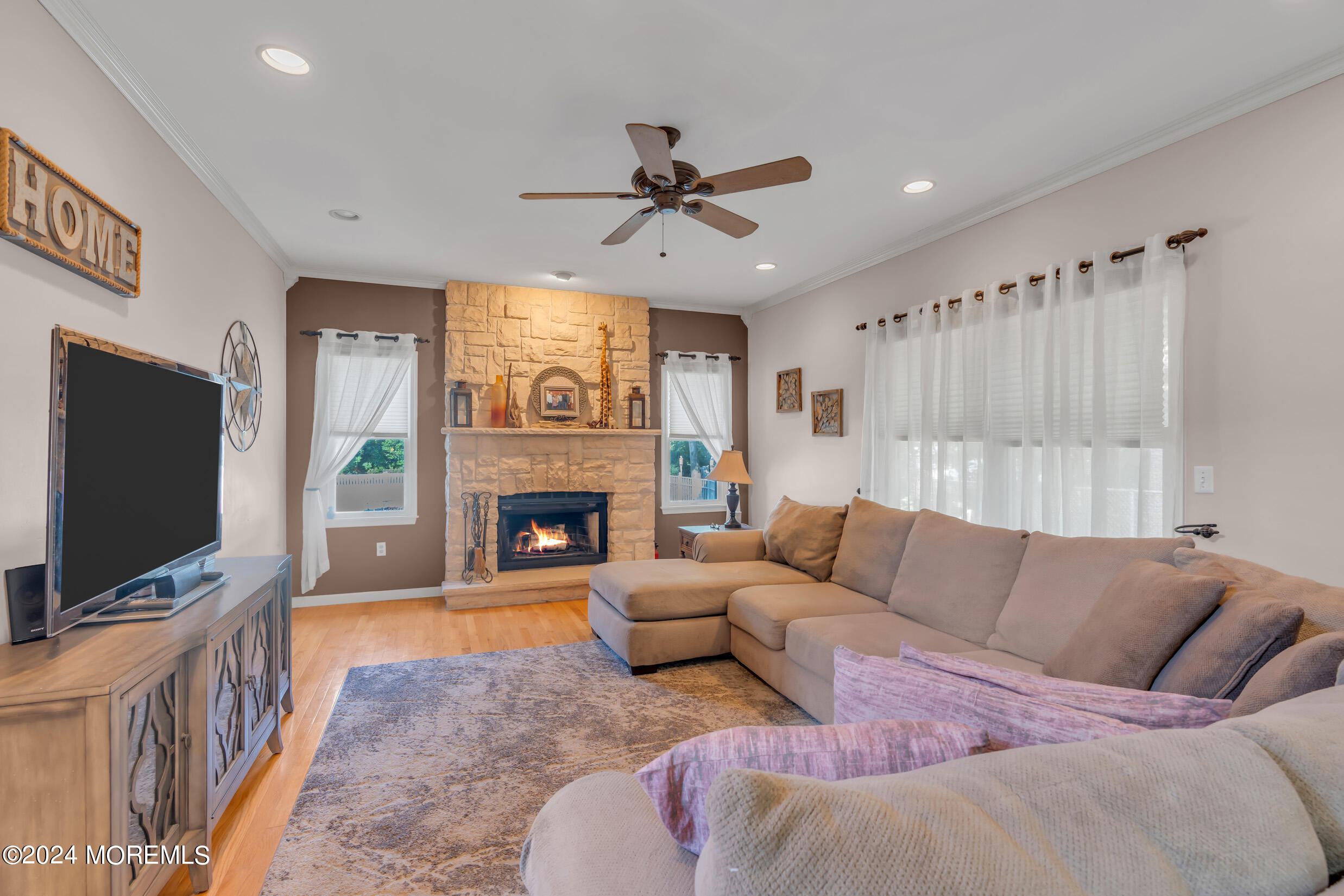 24 Ryjac Court Brick, NJ 08724 - Photo 22 of 57 a living room with furniture a flat screen tv and a fireplace