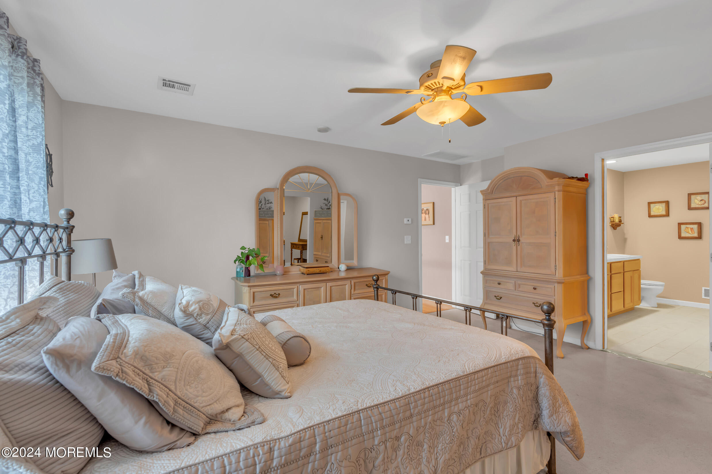 24 Ryjac Court Brick, NJ 08724 - Photo 29 of 57 a bedroom with a bed and a chandelier