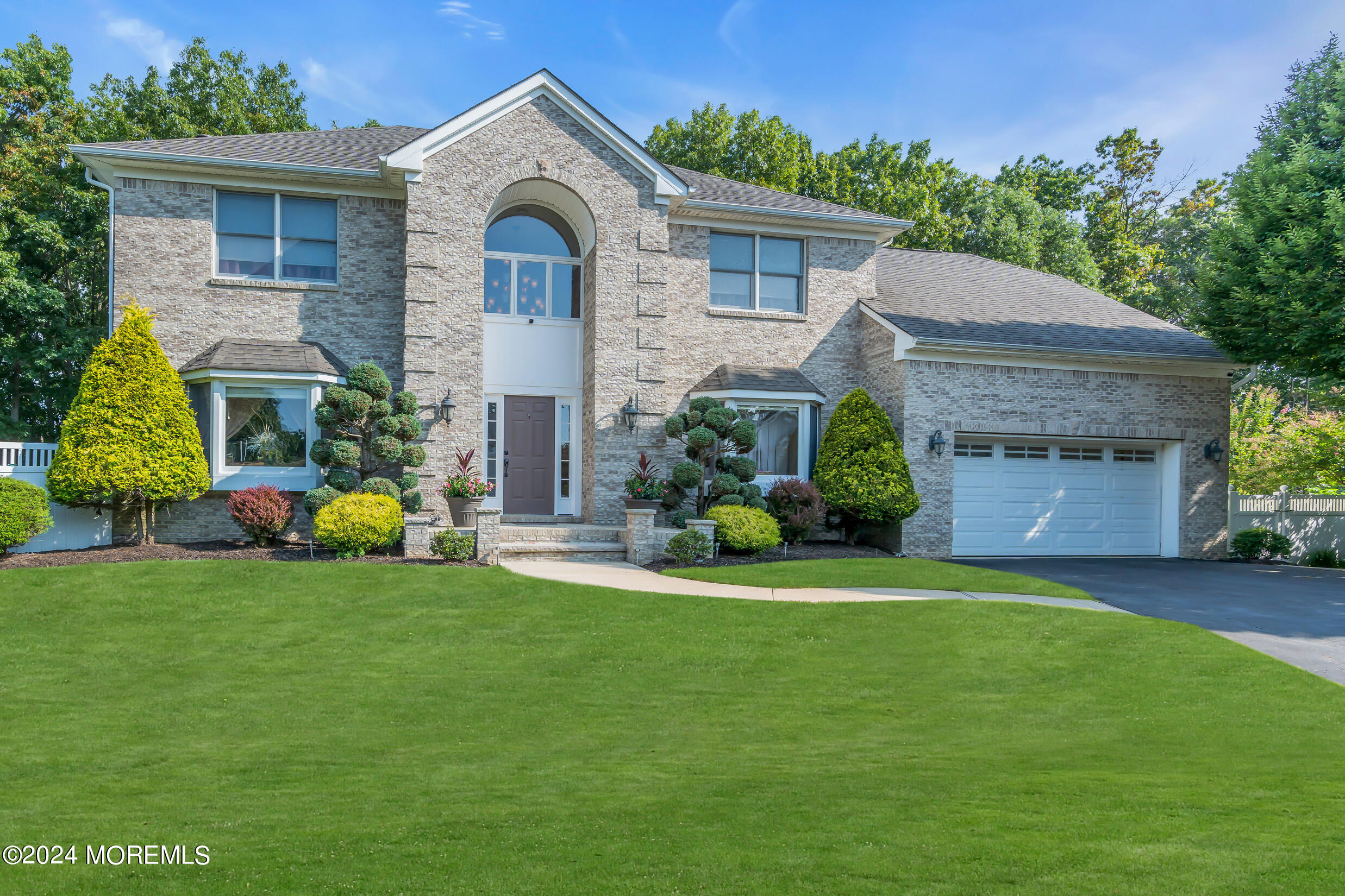 24 Ryjac Court Brick, NJ 08724 - Photo 3 of 57 a front view of a house with a garden and yard