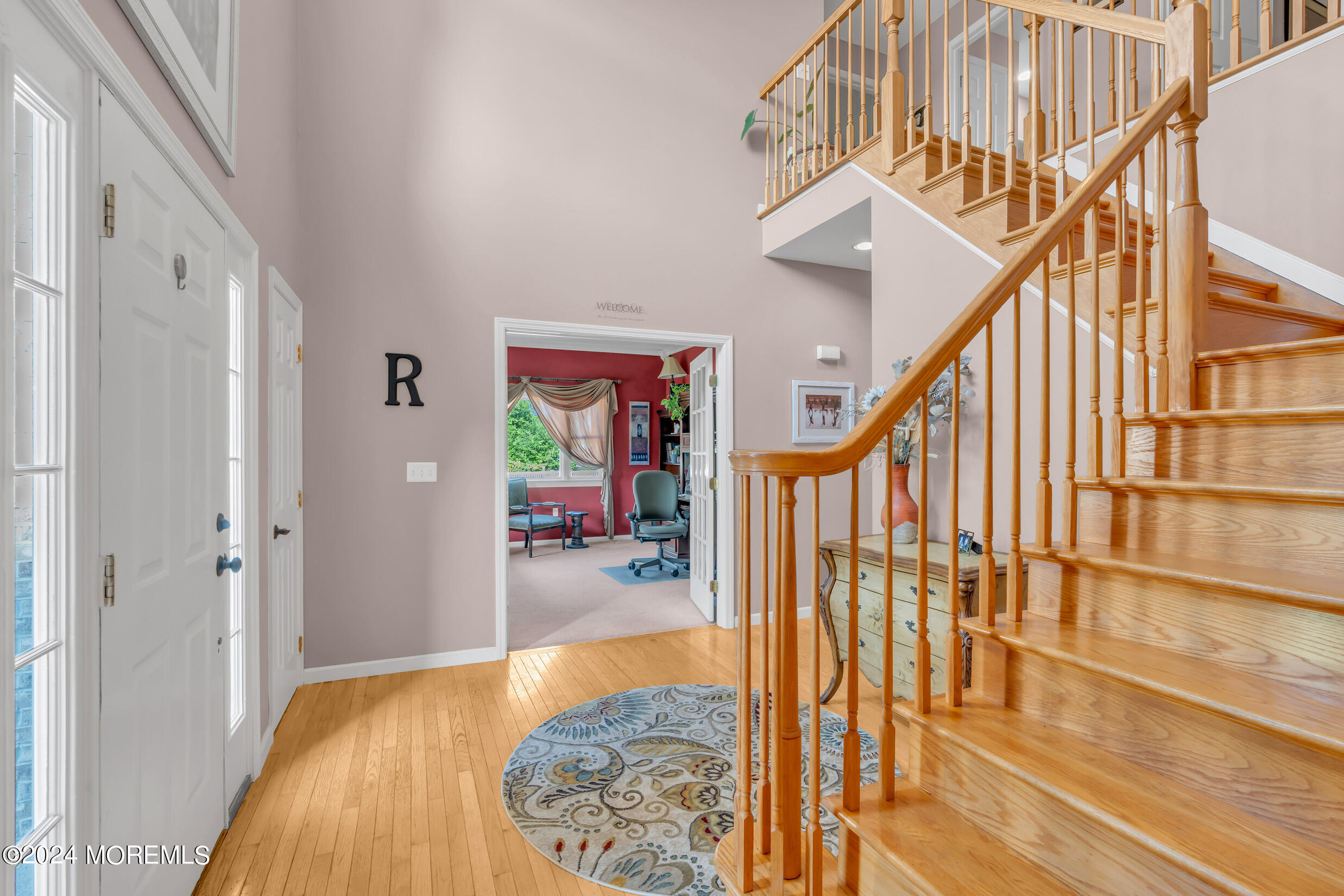 24 Ryjac Court Brick, NJ 08724 - Photo 8 of 57 a view of entryway dining room and hall with wooden floor