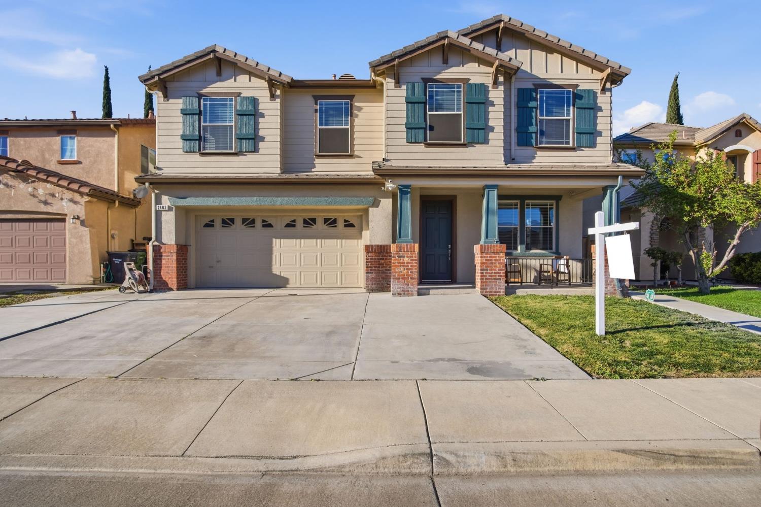 2403 Clemente Lane Tracy, CA 95377 - Photo 1 of 43 a front view of a house with a yard and a garage