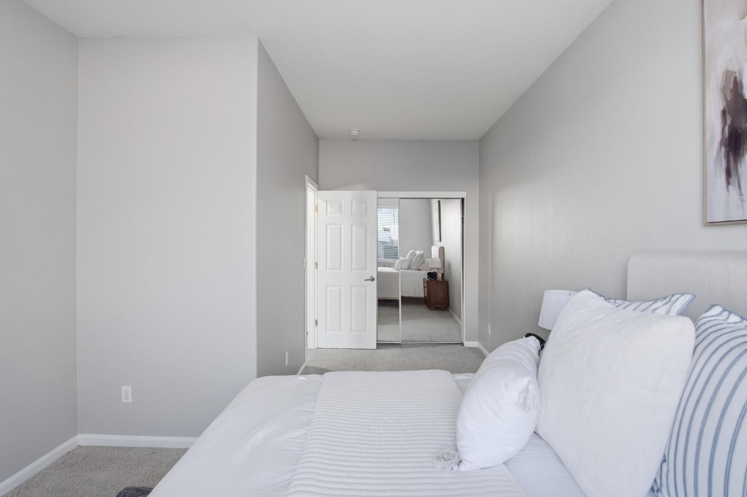 2403 Clemente Lane Tracy, CA 95377 - Photo 18 of 43 a bedroom with a bed and a mirror