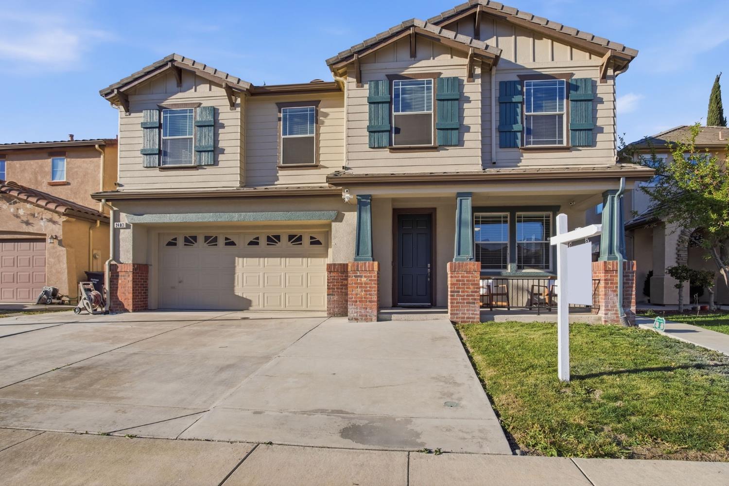 2403 Clemente Lane Tracy, CA 95377 - Photo 2 of 43 a front view of a house with garden