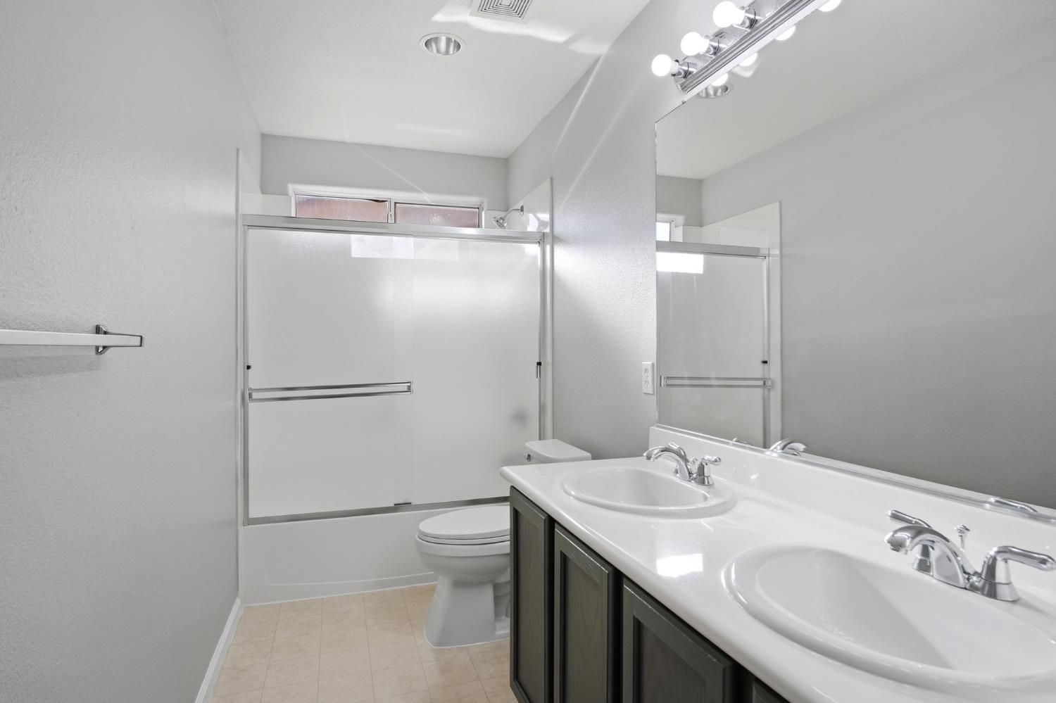 2403 Clemente Lane Tracy, CA 95377 - Photo 23 of 43 a bathroom with a sink a toilet and shower