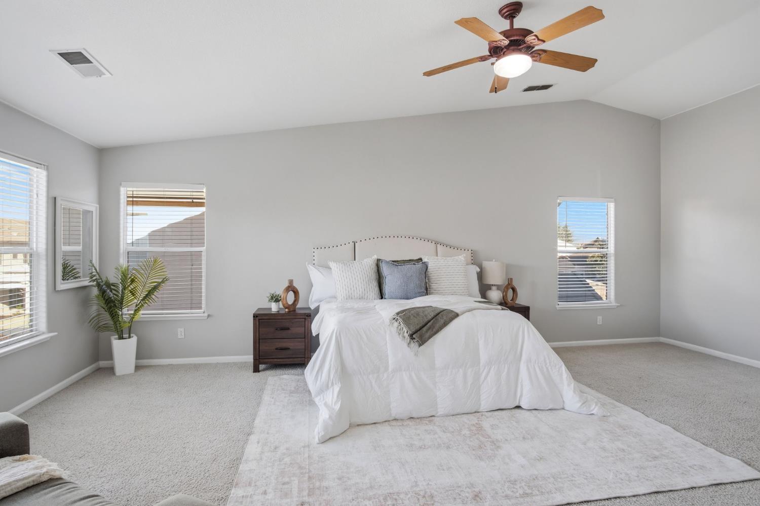 2403 Clemente Lane Tracy, CA 95377 - Photo 27 of 43 a bedroom with a large bed and a chandelier fan