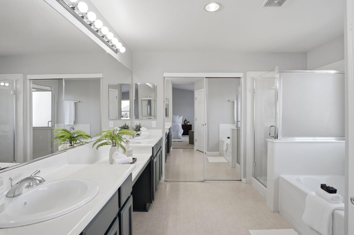 2403 Clemente Lane Tracy, CA 95377 - Photo 28 of 43 a spacious bathroom with a tub a mirror and vanity