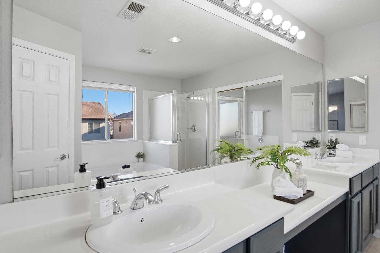 2403 Clemente Lane Tracy, CA 95377 - Photo 29 of 43 a bathroom with a sink and a mirror