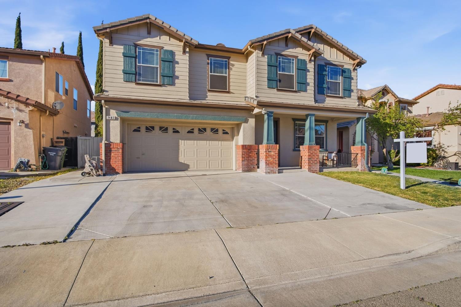 2403 Clemente Lane Tracy, CA 95377 - Photo 3 of 43 a front view of a house with a yard