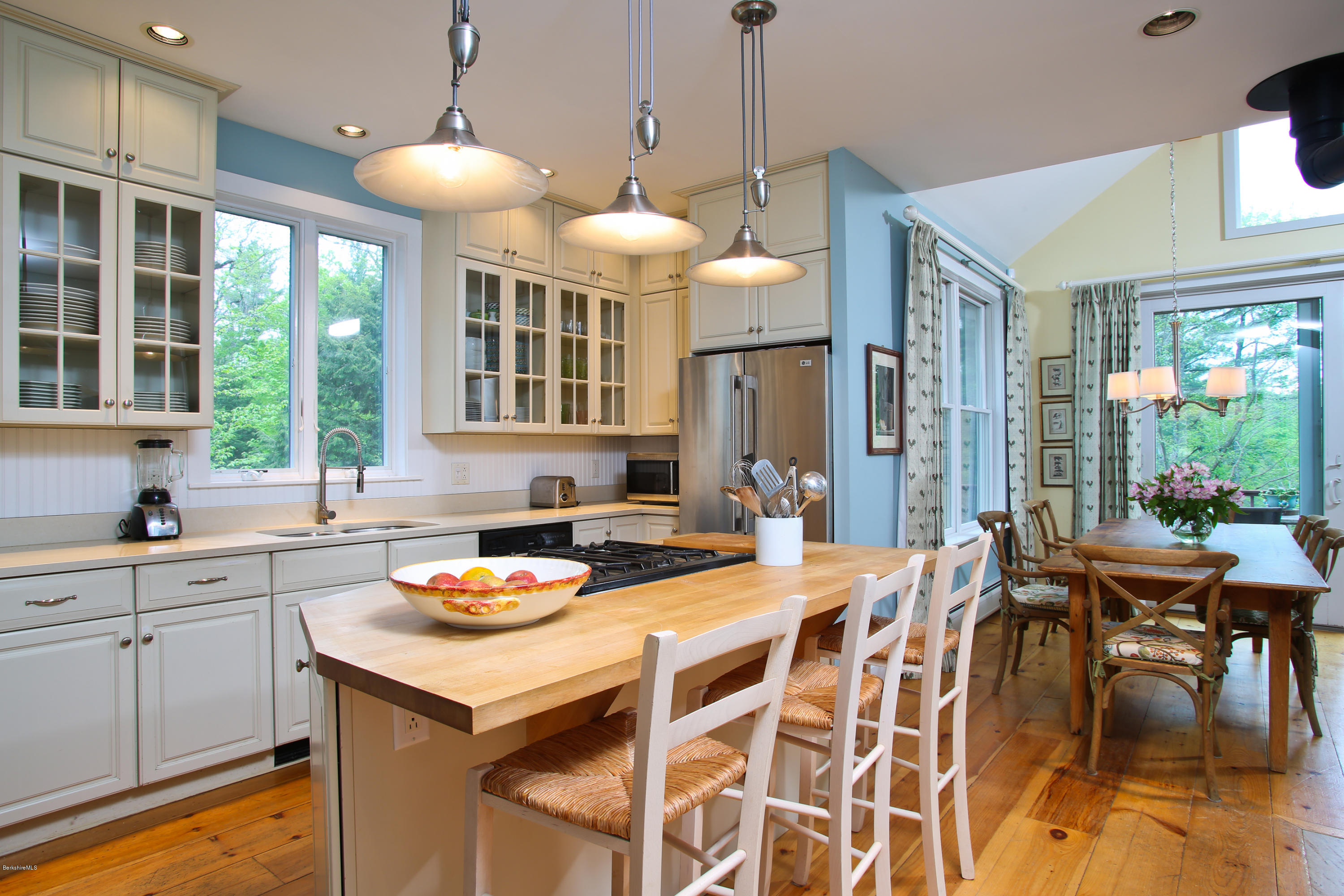 238 Rossiter Road Richmond, MA 01254 - Photo 12 of 41 a kitchen with stainless steel appliances kitchen island granite countertop a dining table and chairs