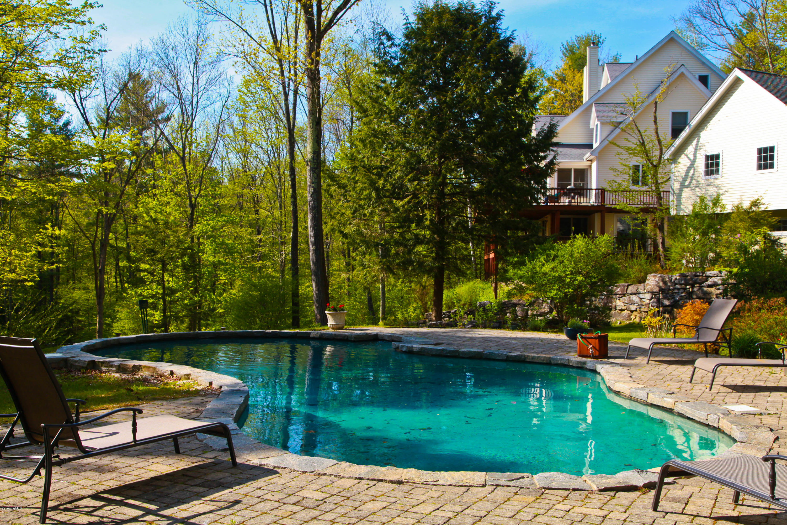 238 Rossiter Road Richmond, MA 01254 - Photo 30 of 41 a view of a lake with lawn chairs under an umbrella