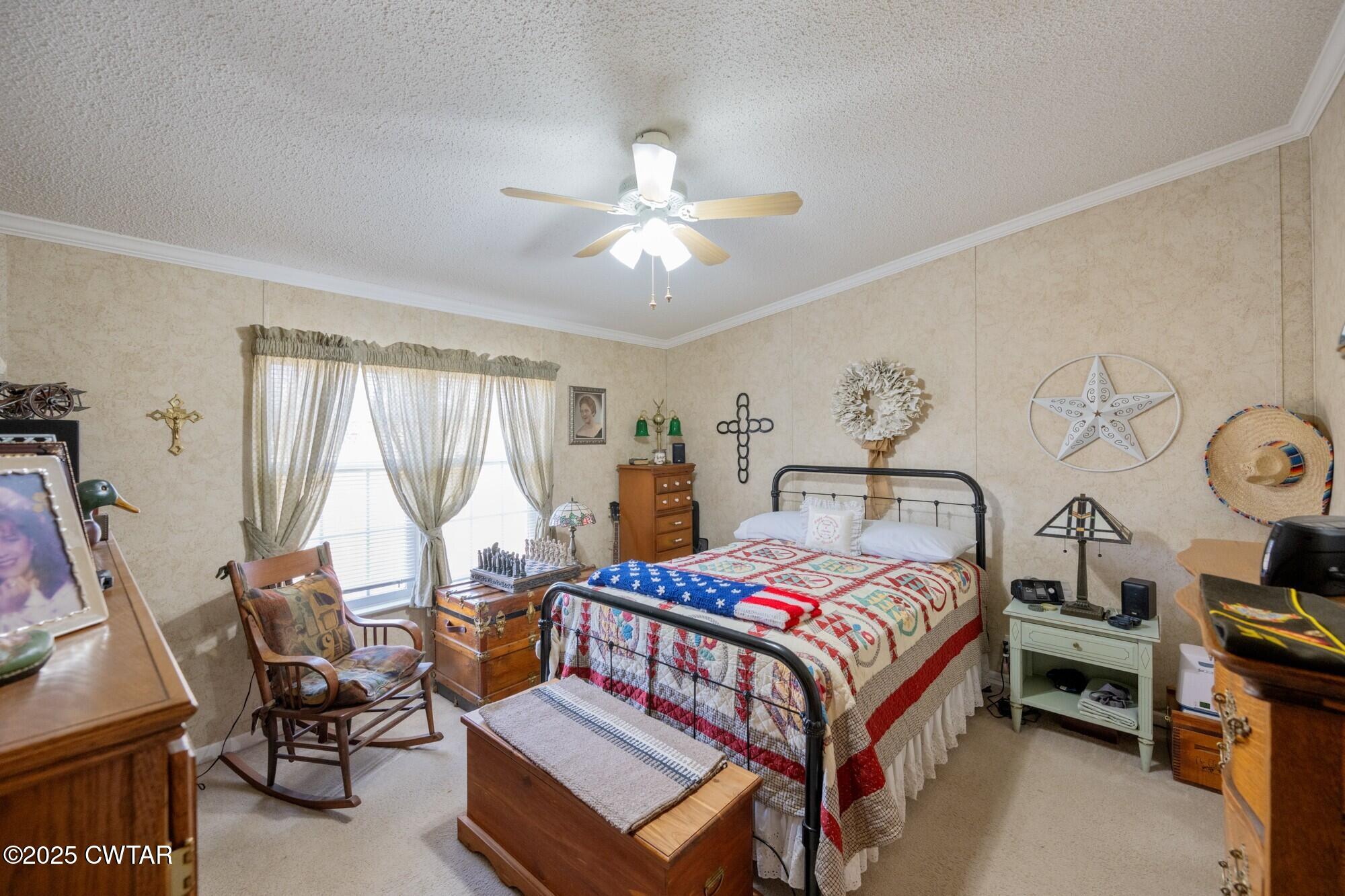 416 Haney School Road Decaturville, TN 38329 - Photo 16 of 35 a bedroom with a bed and a chandelier