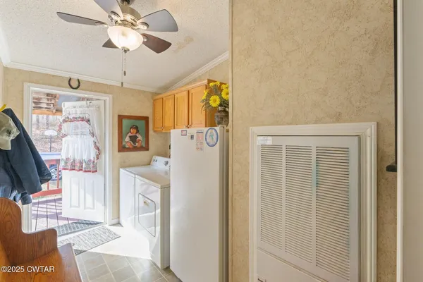 a view of a livingroom with wooden floor and ceiling fan