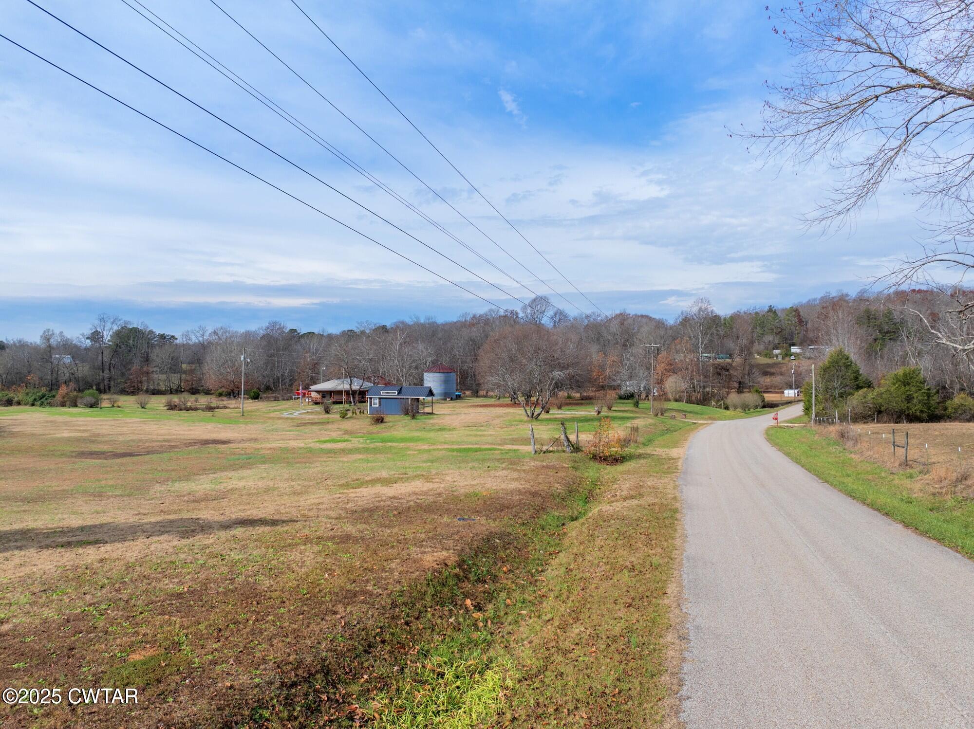 416 Haney School Road Decaturville, TN 38329 - Photo 33 of 35 a view of a lake with a yard and mountain view