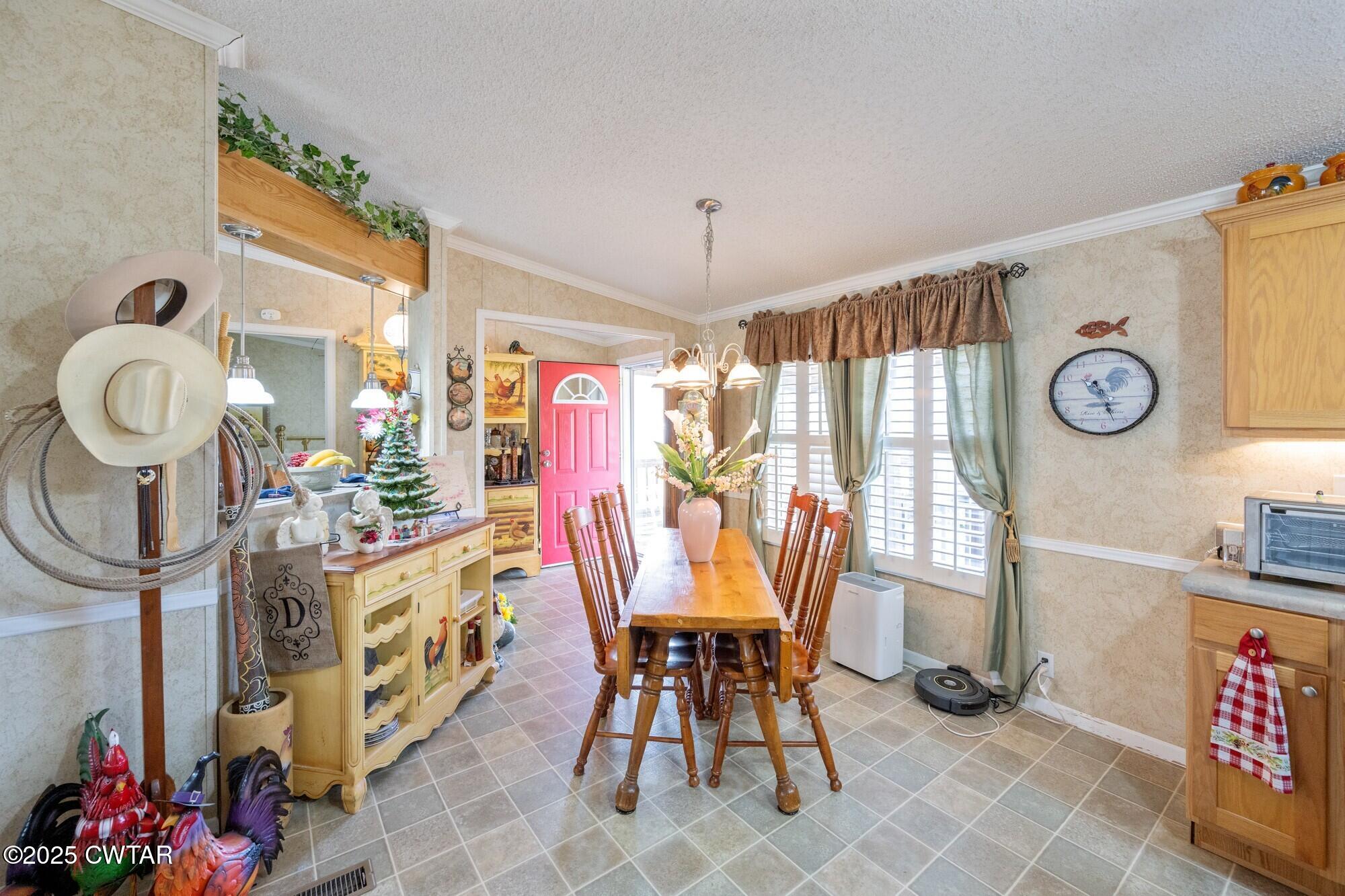 416 Haney School Road Decaturville, TN 38329 - Photo 6 of 35 a view of a dining room with furniture and chandelier