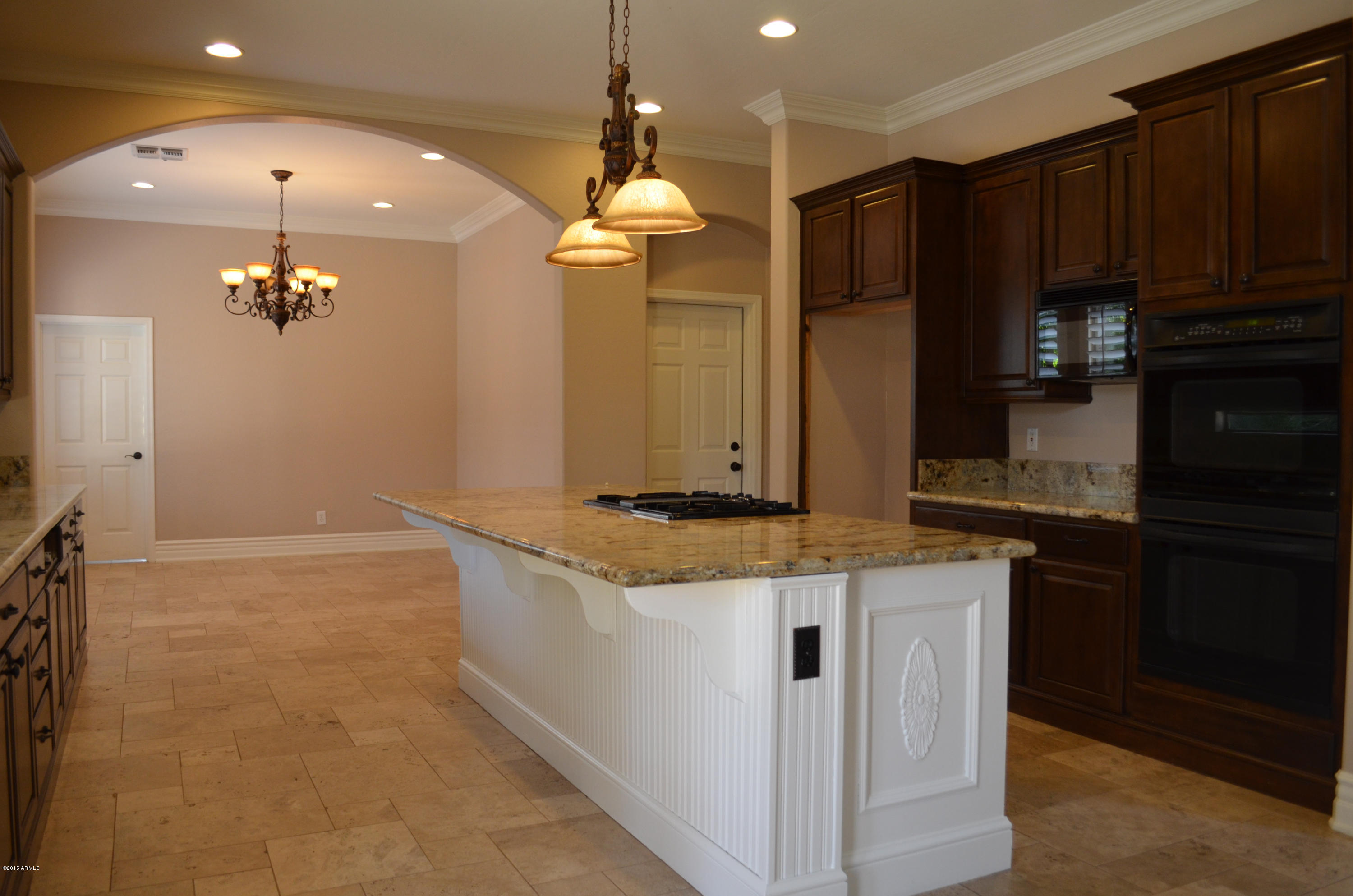 2941 Washington Avenue Gilbert, AZ 85234 - Photo 19 of 57 a kitchen with kitchen island granite countertop a sink and a refrigerator