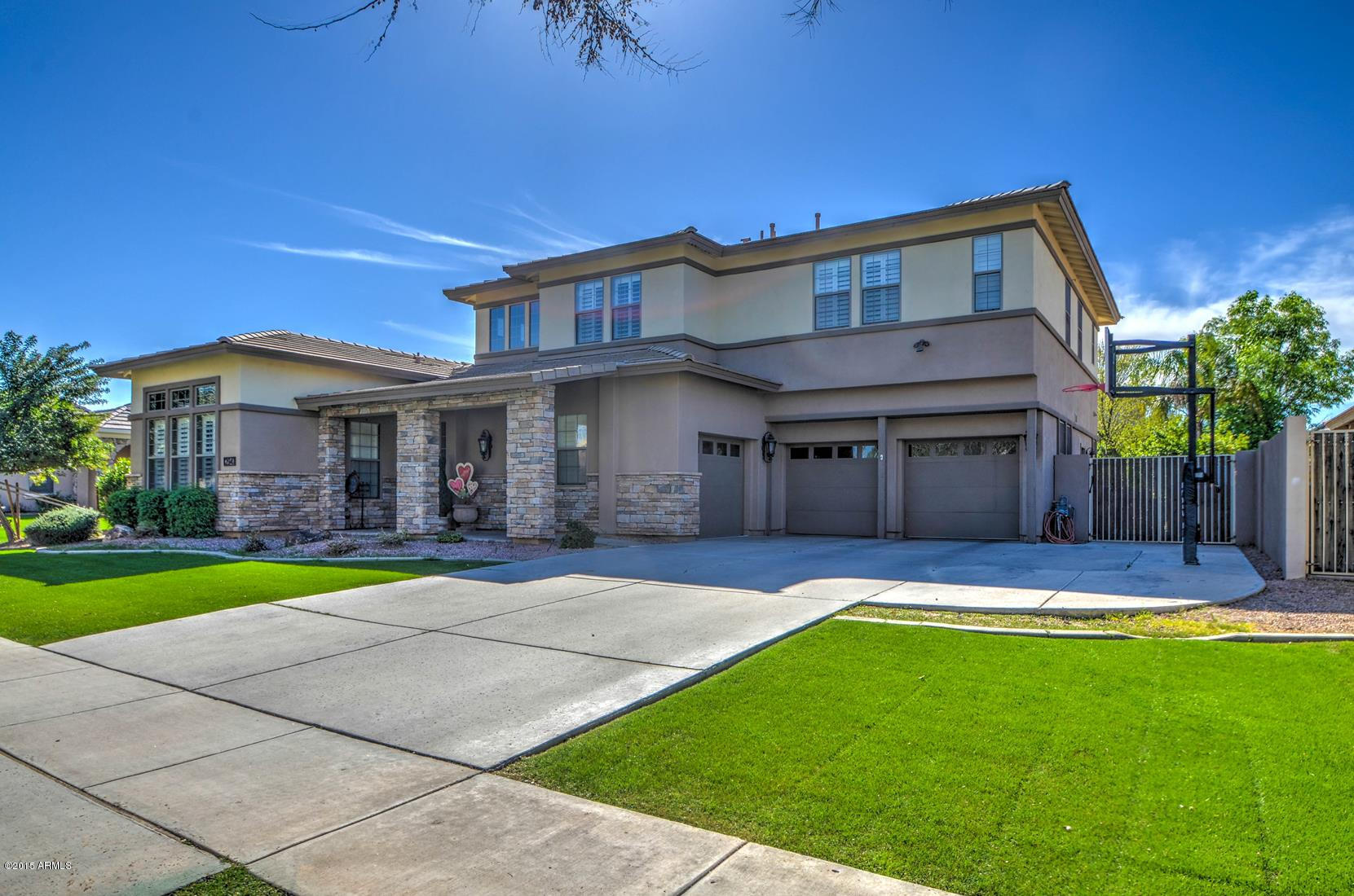 2941 Washington Avenue Gilbert, AZ 85234 - Photo 2 of 57 a front view of a house with a yard and garage