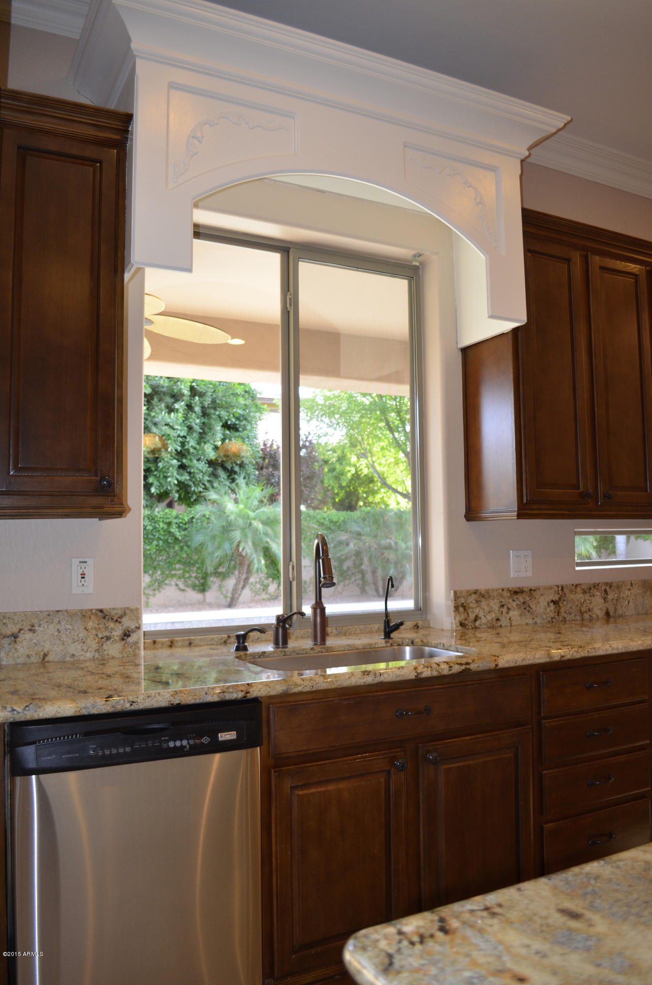 2941 Washington Avenue Gilbert, AZ 85234 - Photo 24 of 57 a kitchen with granite countertop a sink and a window