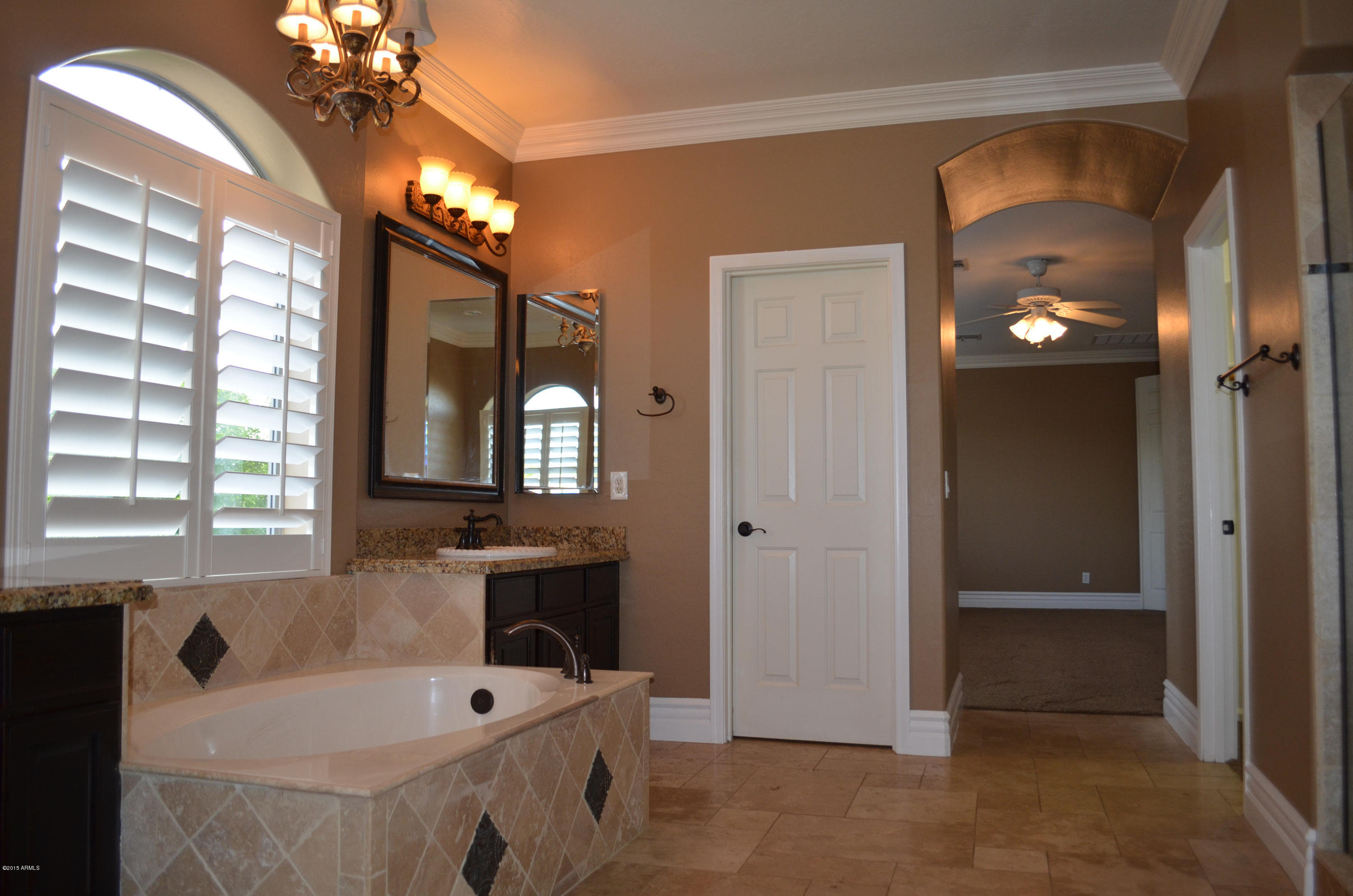 2941 Washington Avenue Gilbert, AZ 85234 - Photo 33 of 57 a bathroom with a tub a sink and a large mirror