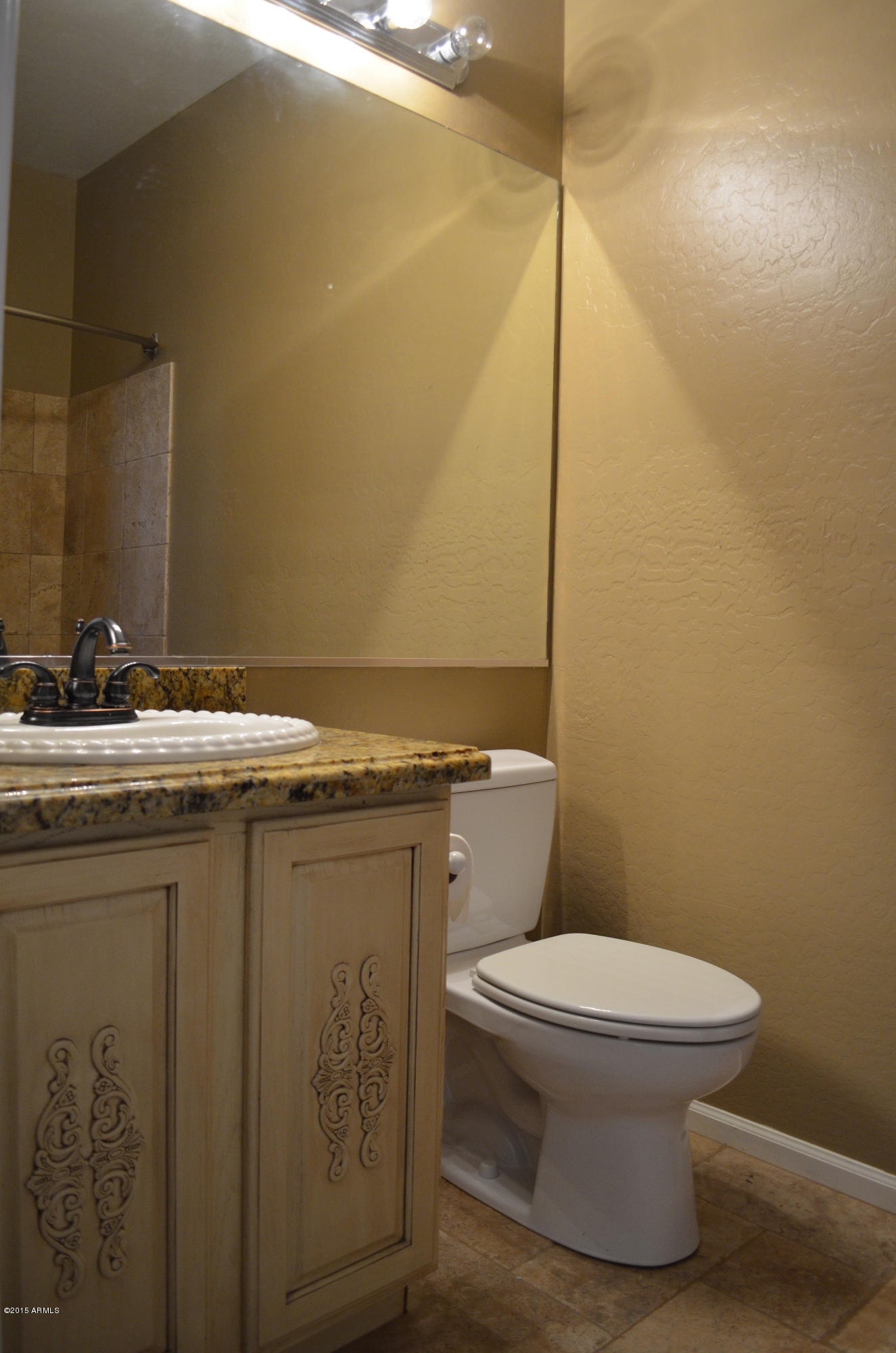 2941 Washington Avenue Gilbert, AZ 85234 - Photo 37 of 57 a bathroom with a granite countertop sink toilet and a mirror