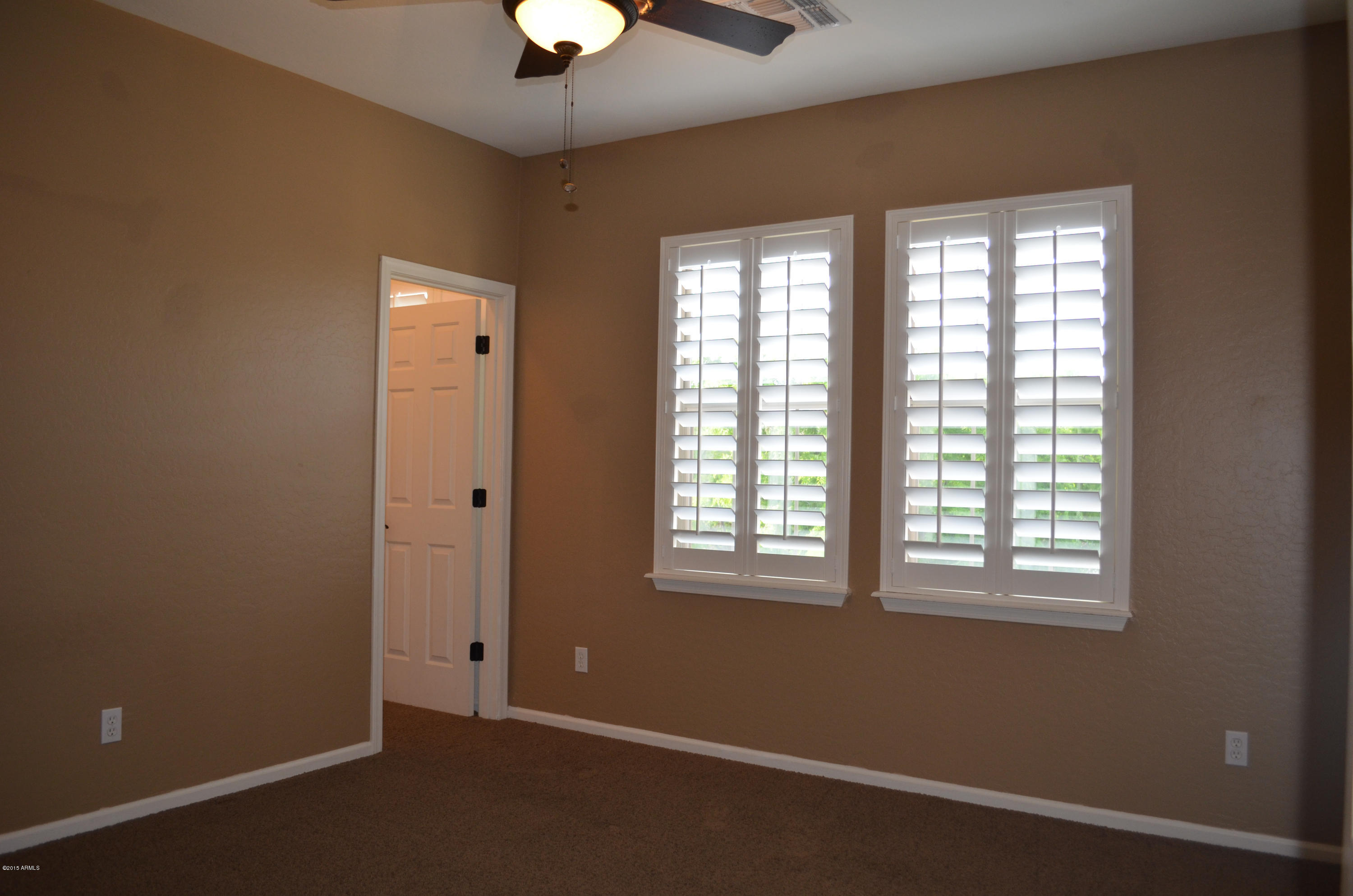 2941 Washington Avenue Gilbert, AZ 85234 - Photo 38 of 57 an empty room with a window and a ceiling fan