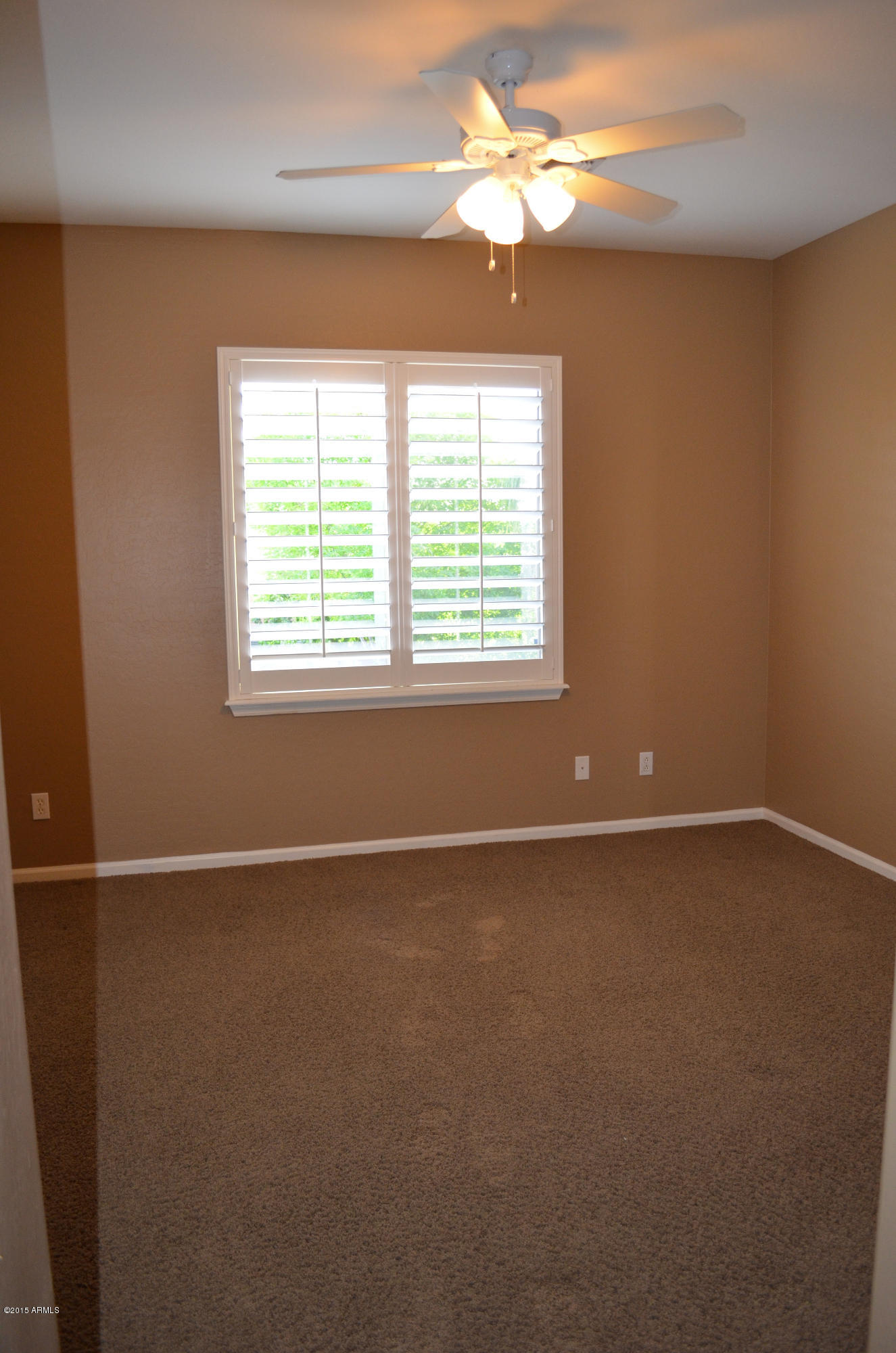 2941 Washington Avenue Gilbert, AZ 85234 - Photo 41 of 57 an empty room with a window and a fan