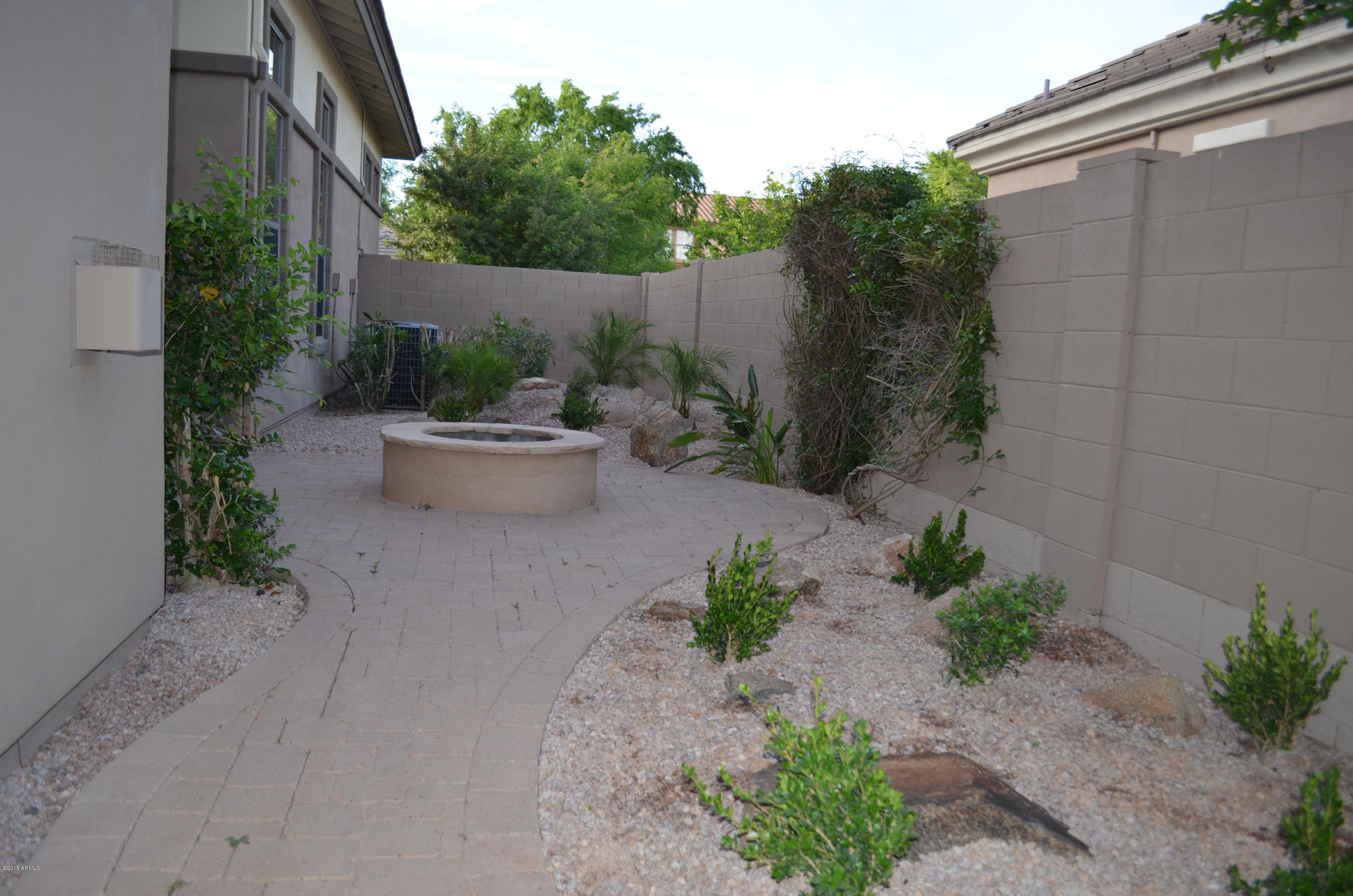 2941 Washington Avenue Gilbert, AZ 85234 - Photo 46 of 57 a view of a backyard with potted plants and big trees