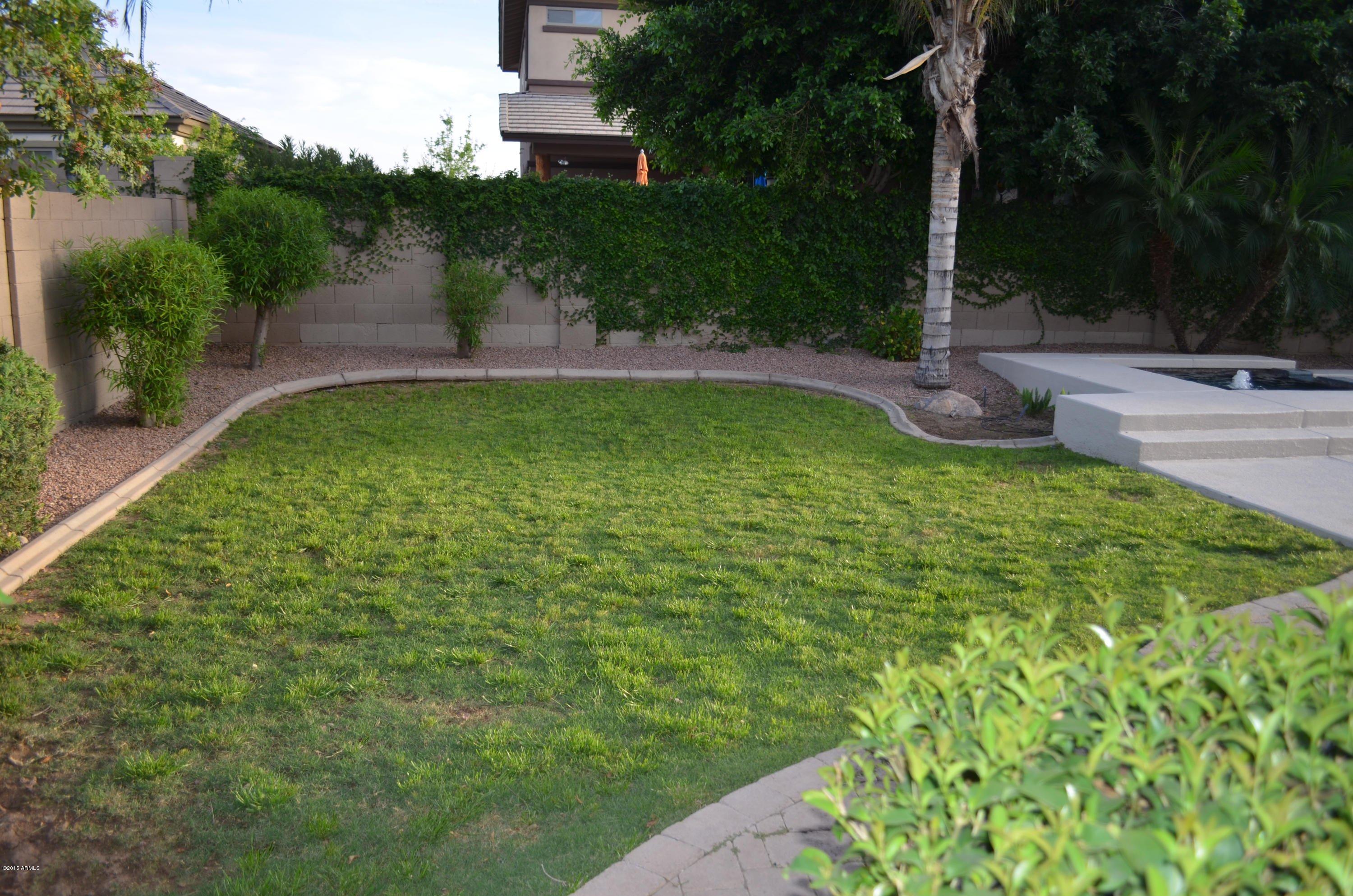 2941 Washington Avenue Gilbert, AZ 85234 - Photo 47 of 57 a view of a backyard with a fountain
