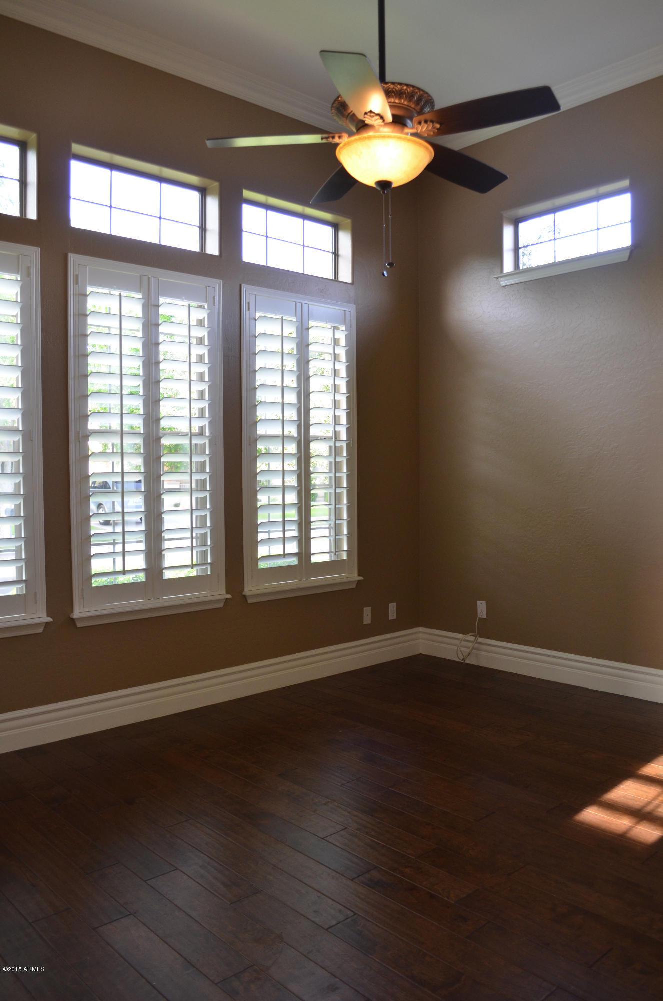 2941 Washington Avenue Gilbert, AZ 85234 - Photo 5 of 57 a view of an empty room with wooden floor and a window