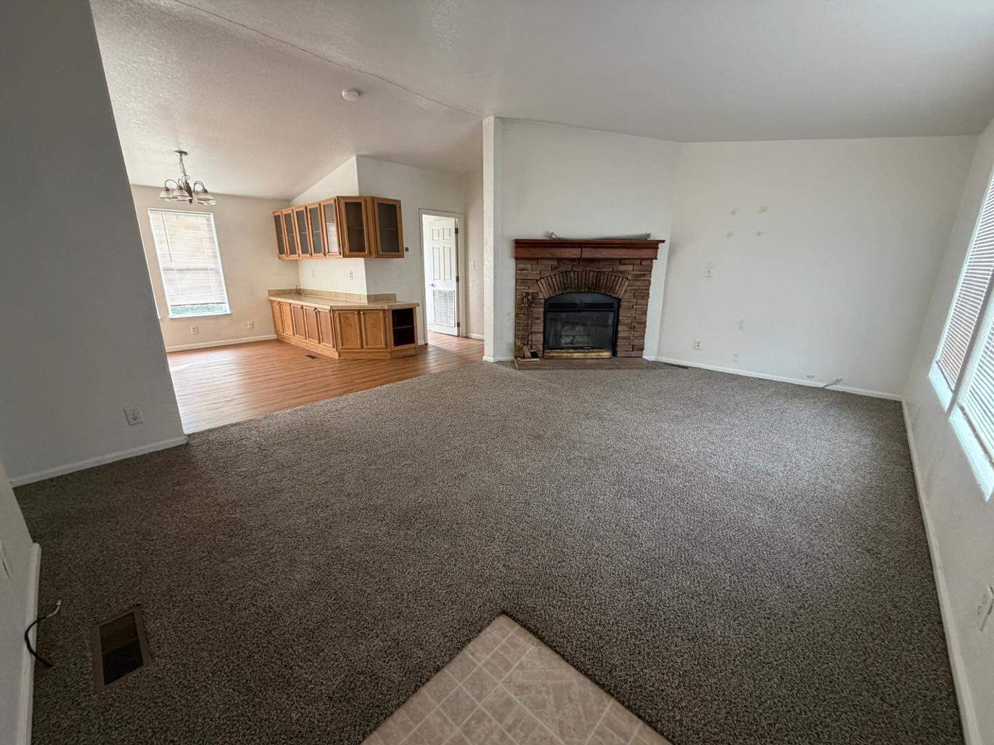 a view of empty room with a fireplace