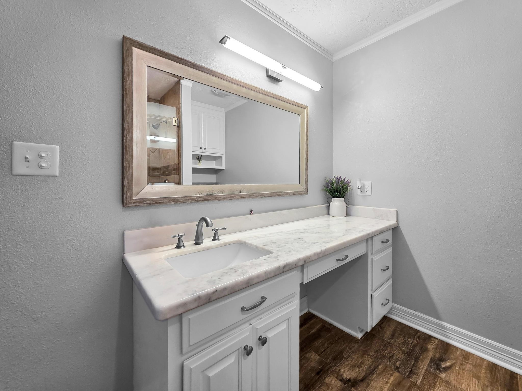 2641 Oilla Road Orange, TX 77630 - Photo 25 of 50 a bathroom with a granite countertop sink a mirror and a