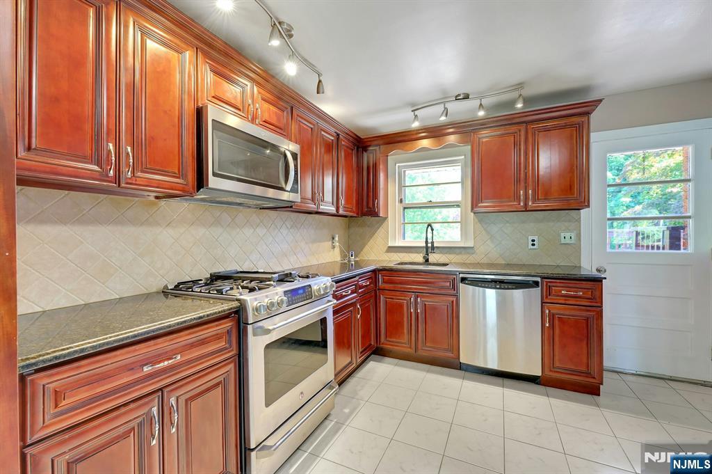 20 Blue Hill Road Norwood, NJ 07648 - Photo 17 of 49 a kitchen with stainless steel appliances granite countertop a stove sink and microwave
