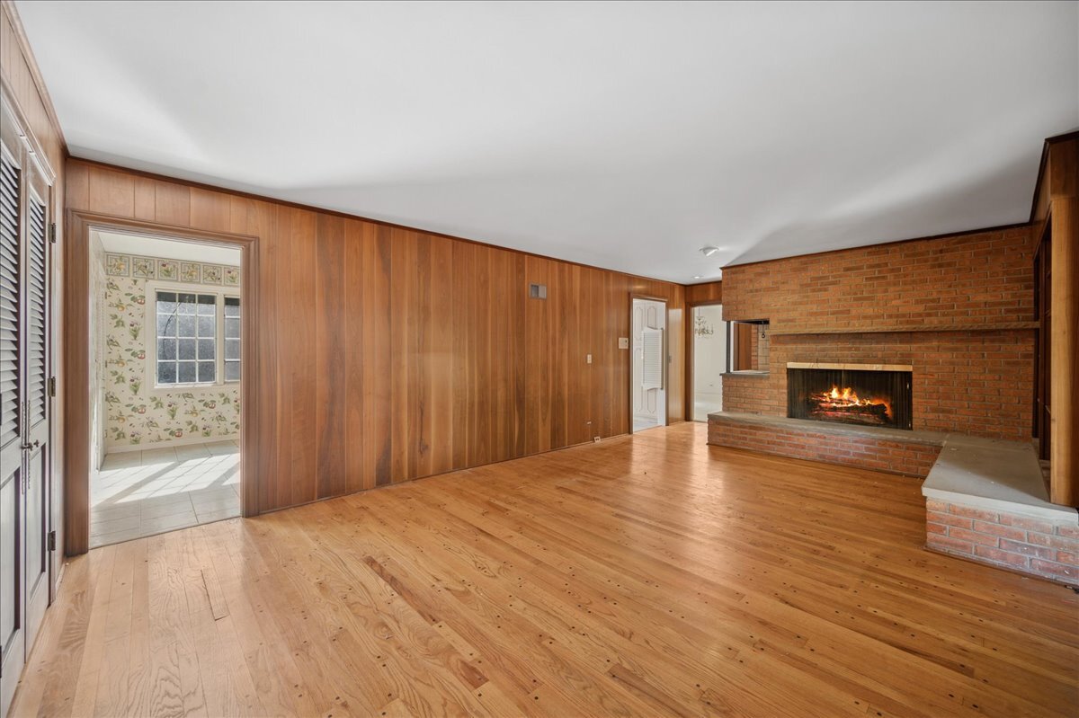 1080 Hillcrest Road Glencoe, IL 60022 - Photo 11 of 33 wooden floor fireplace and windows in an empty room