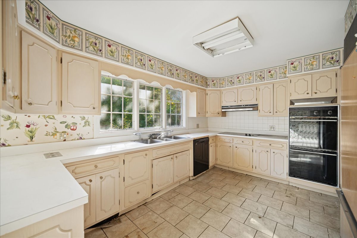 1080 Hillcrest Road Glencoe, IL 60022 - Photo 13 of 33 a kitchen with granite countertop white cabinets and white appliances