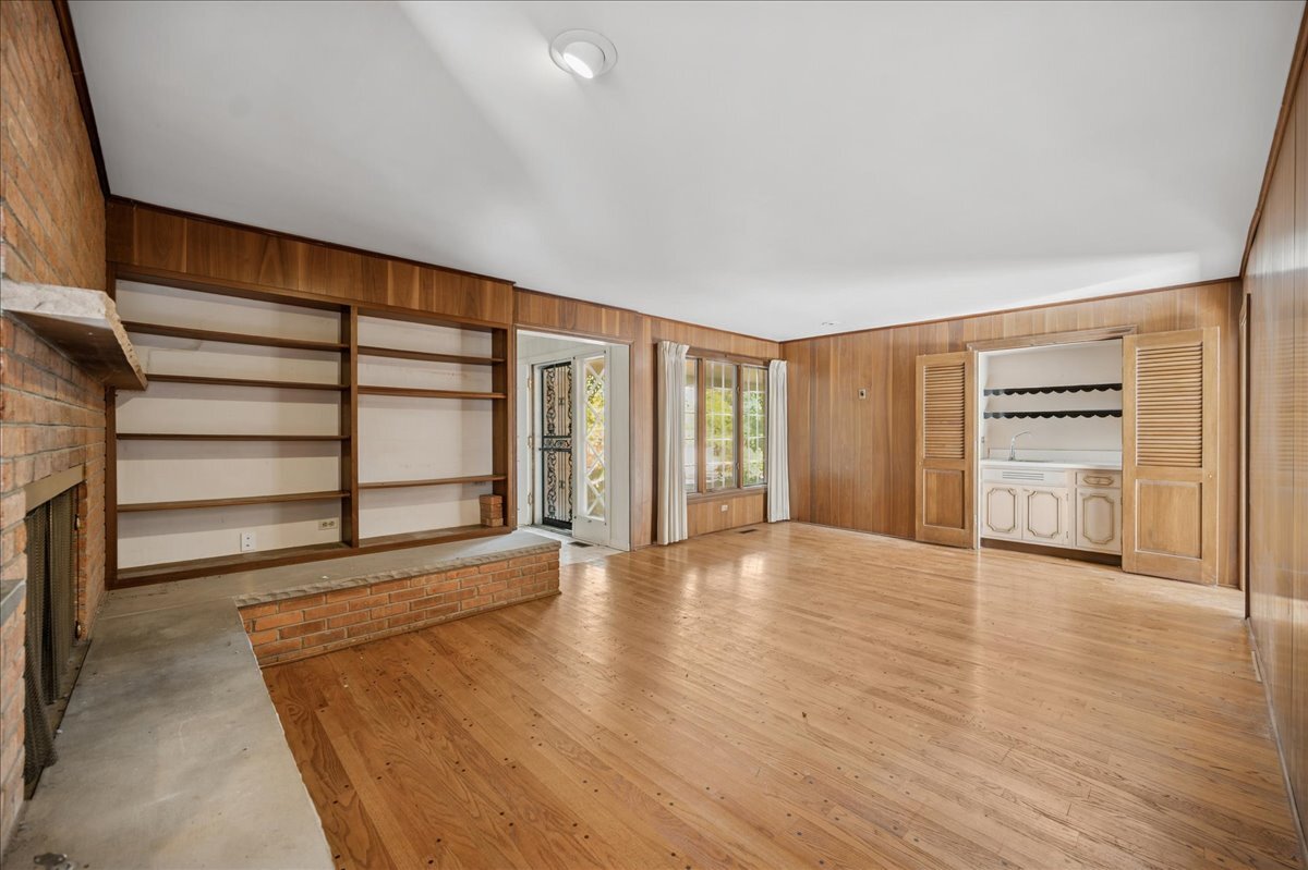 1080 Hillcrest Road Glencoe, IL 60022 - Photo 10 of 33 a view of an empty room with a window and wooden floor